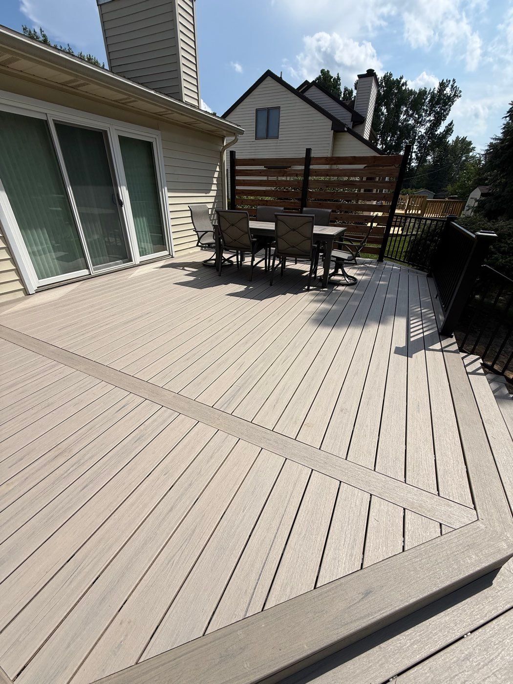 Composite deck with a built-in border and black railing