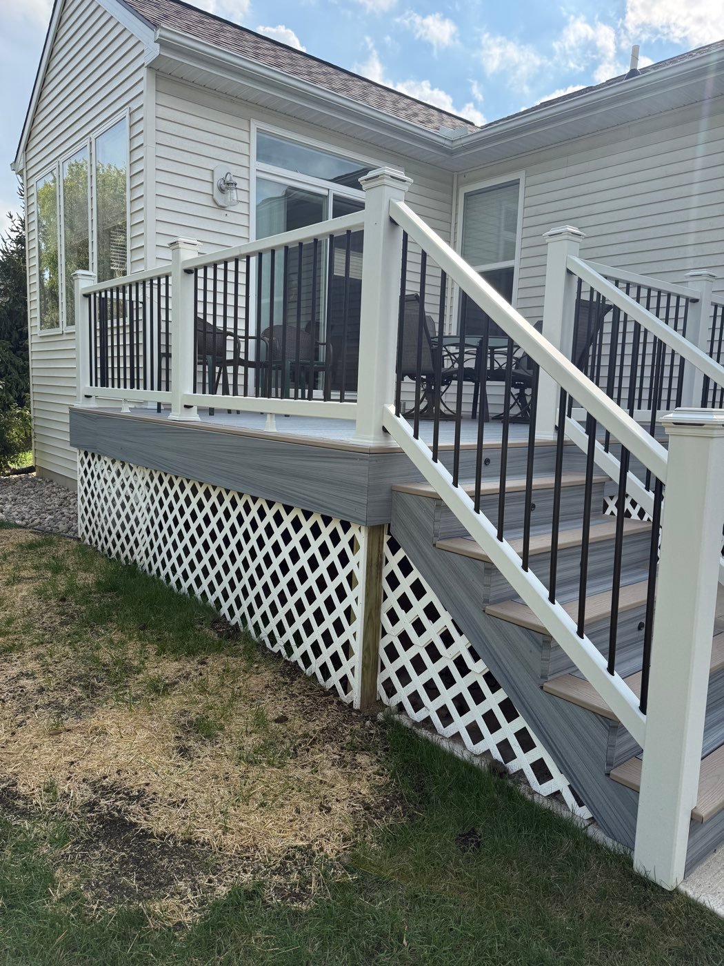 Composite deck with white railing and lattice skirting