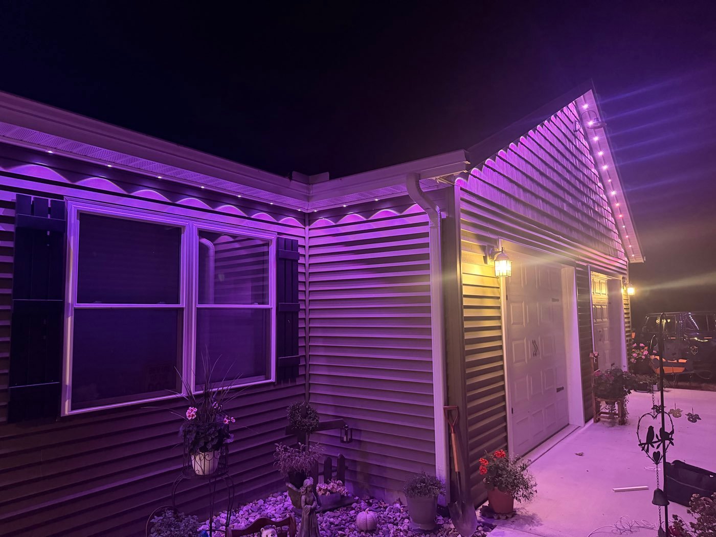 Home with purple soffit and gable lighting at night