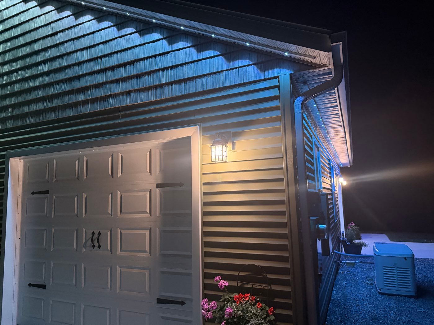 Garage roofline outlined with soffit lighting at night
