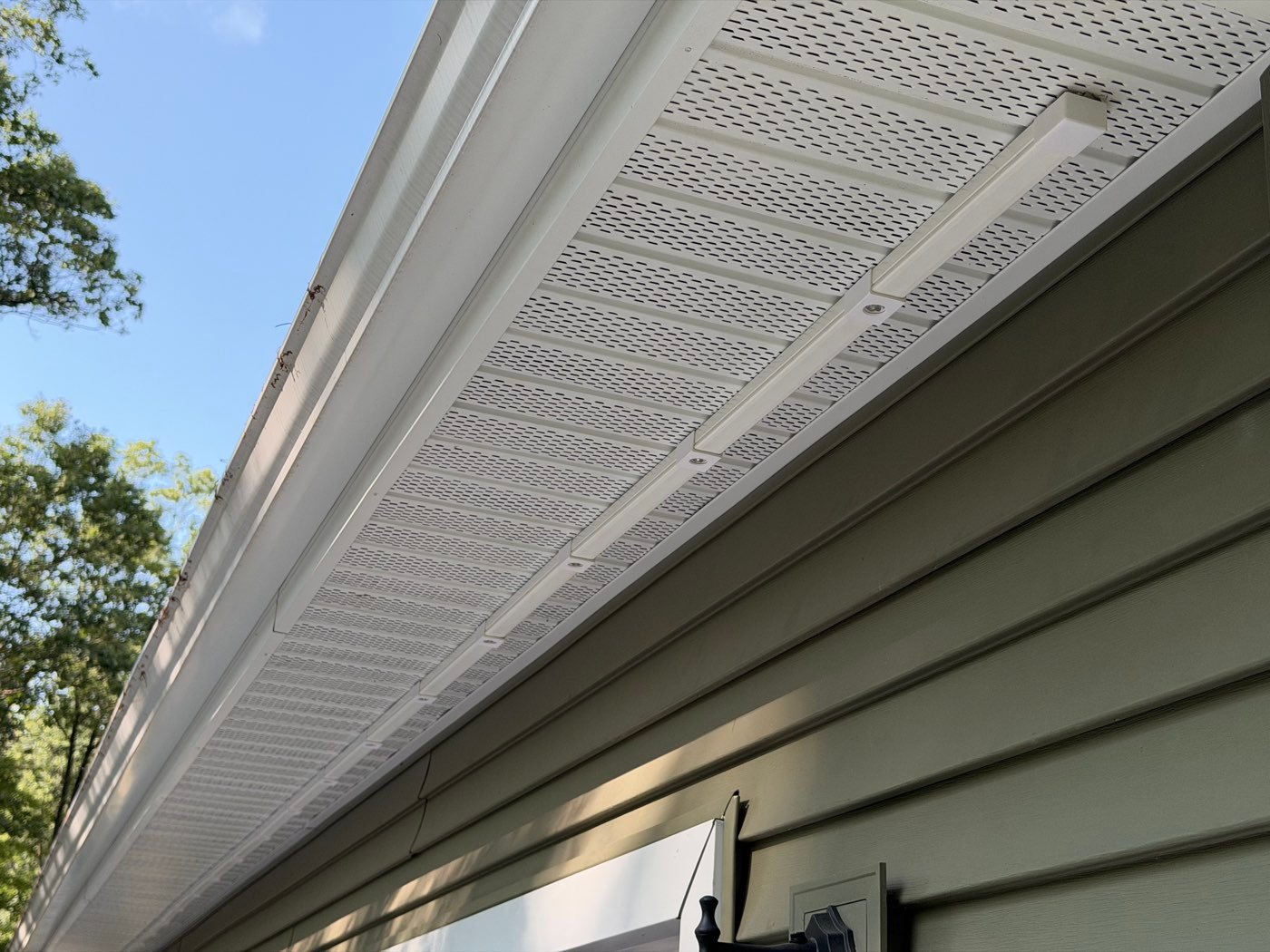 Permanent lighting track installed along the soffit