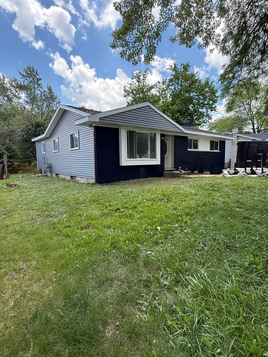 Home with new navy blue siding and white trim