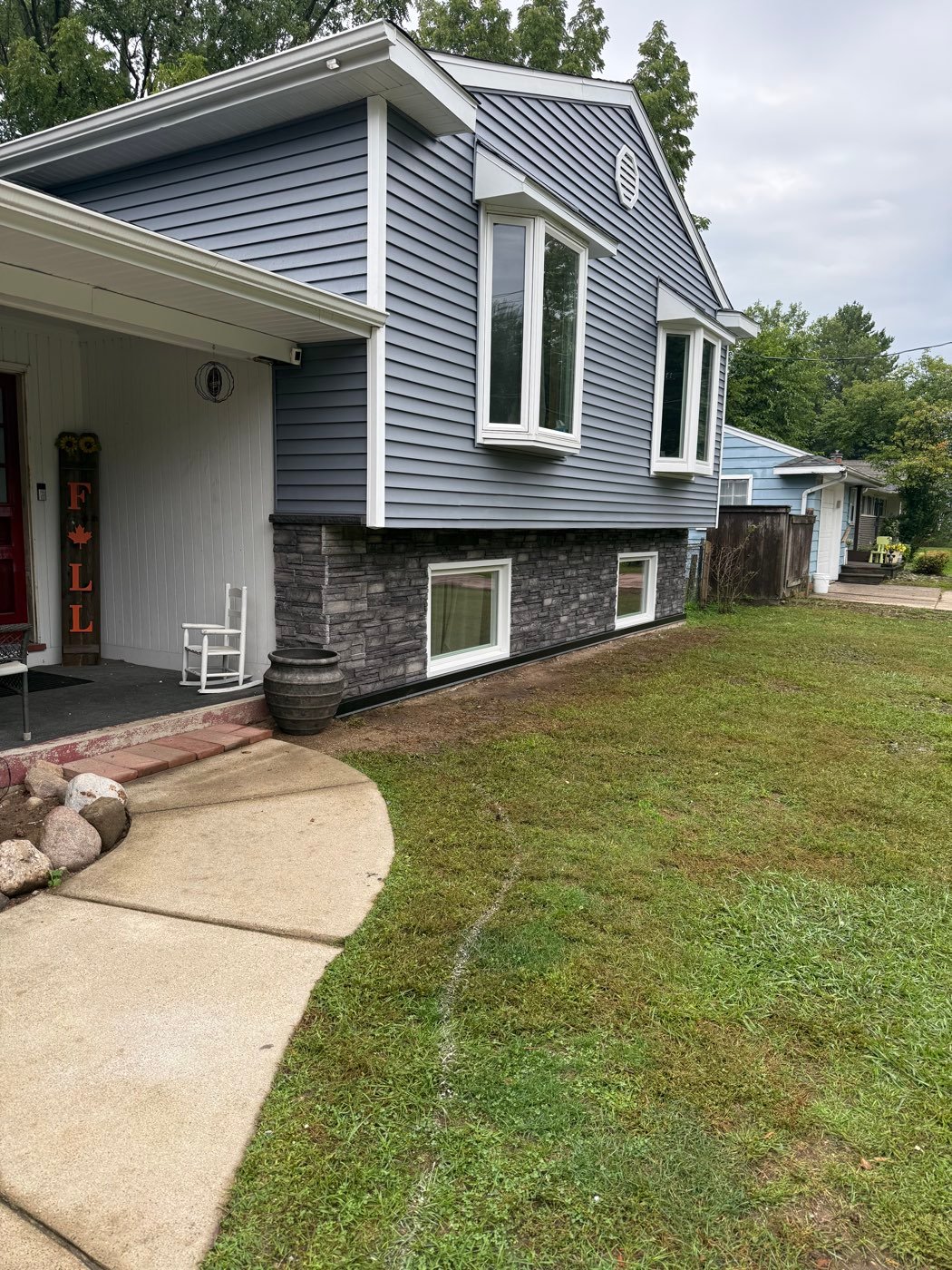 Blue siding with stone accents on a front entry