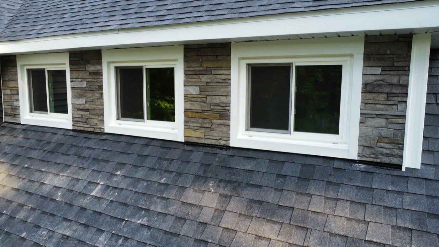 New white-framed sliding windows set in stone, seen from above